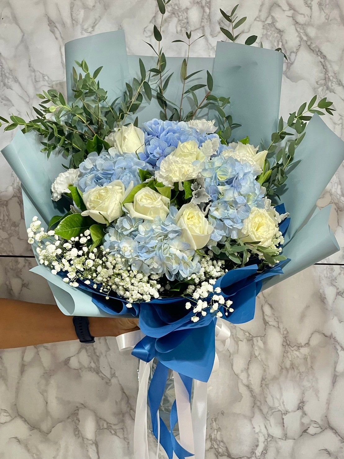 Blue hydrangea with white rose and white paper
