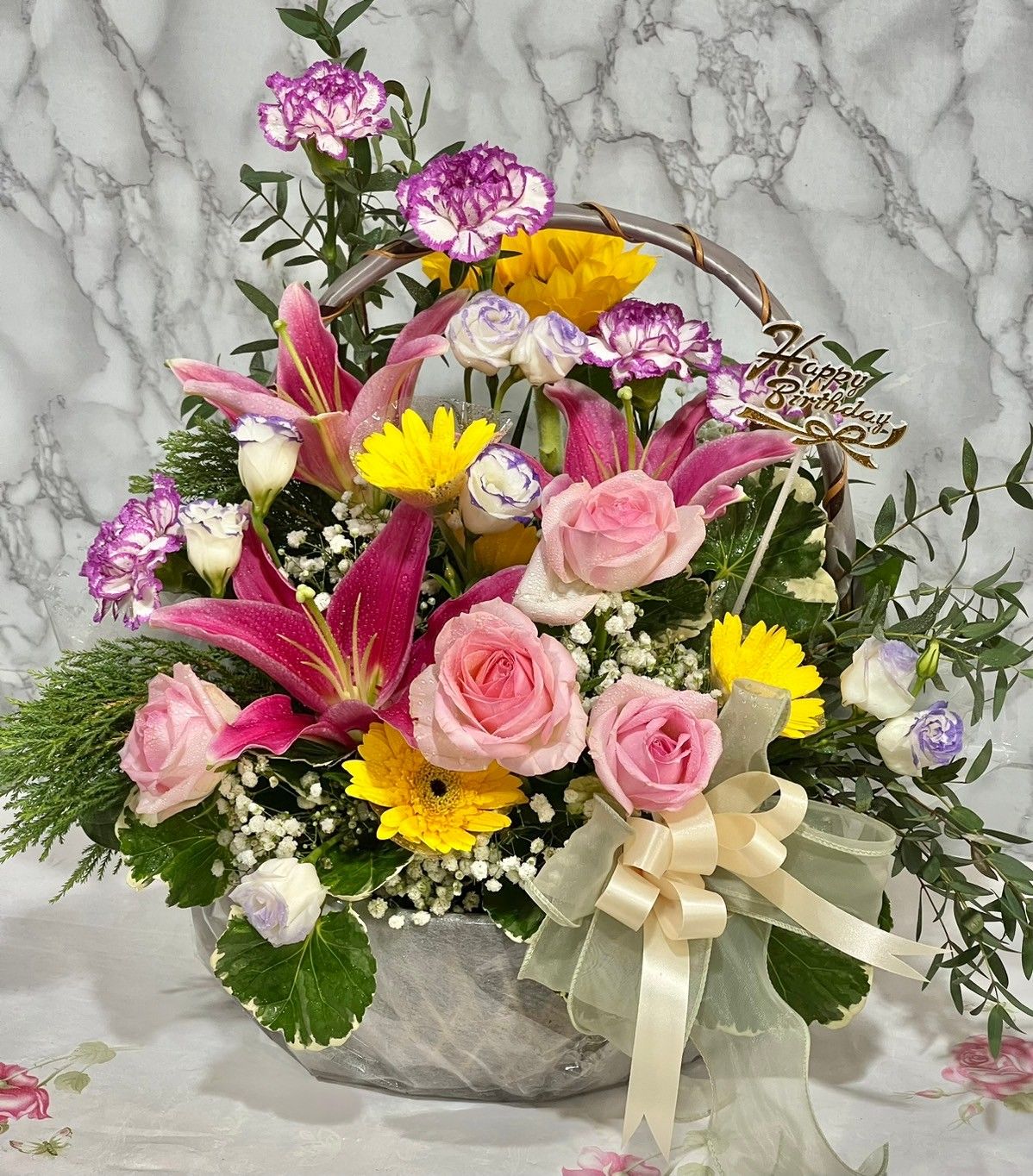 Pink lily and pink rose in basket