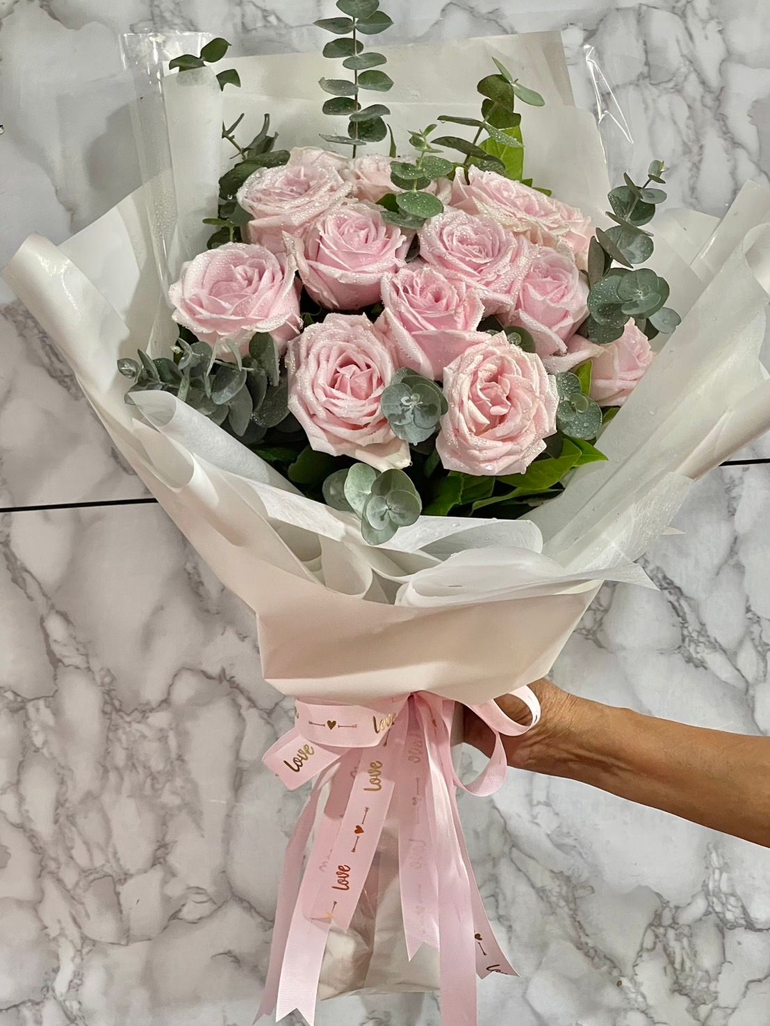 Light pink rose with white paper